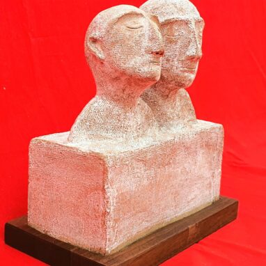Picture of a sculpture depicting two human heads in a sleepy state