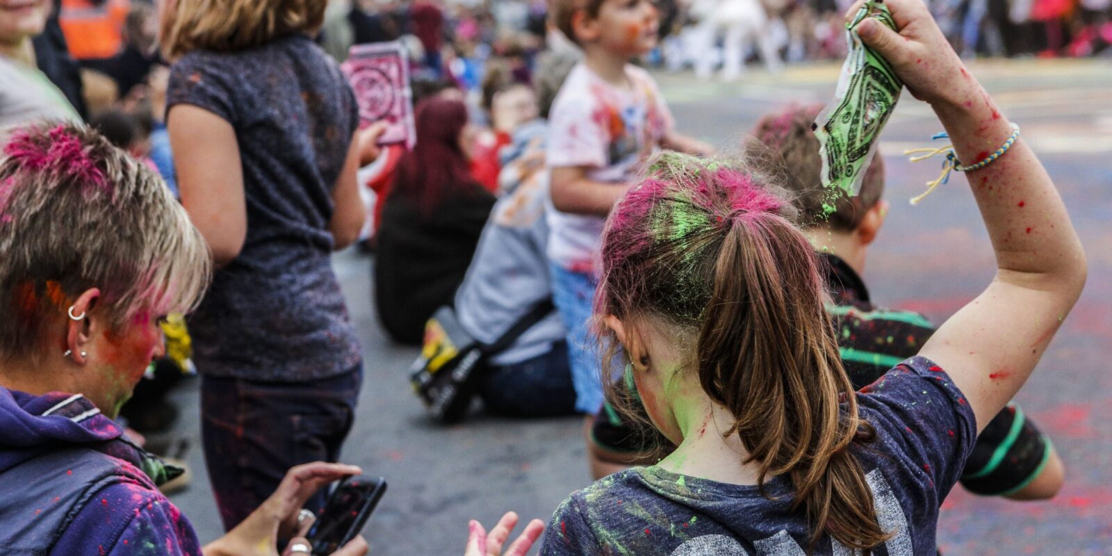 A child pouring dye on their hair as part of the audience