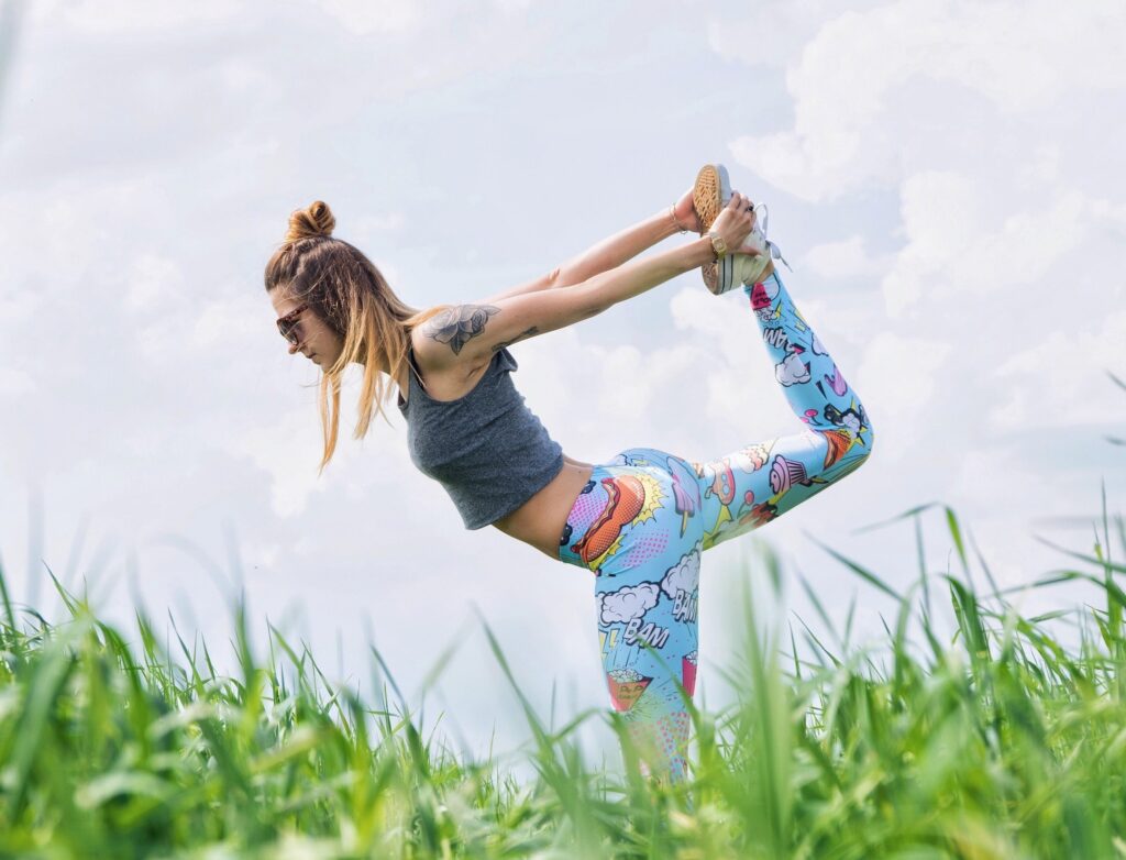 Girl stretching yoga in a field