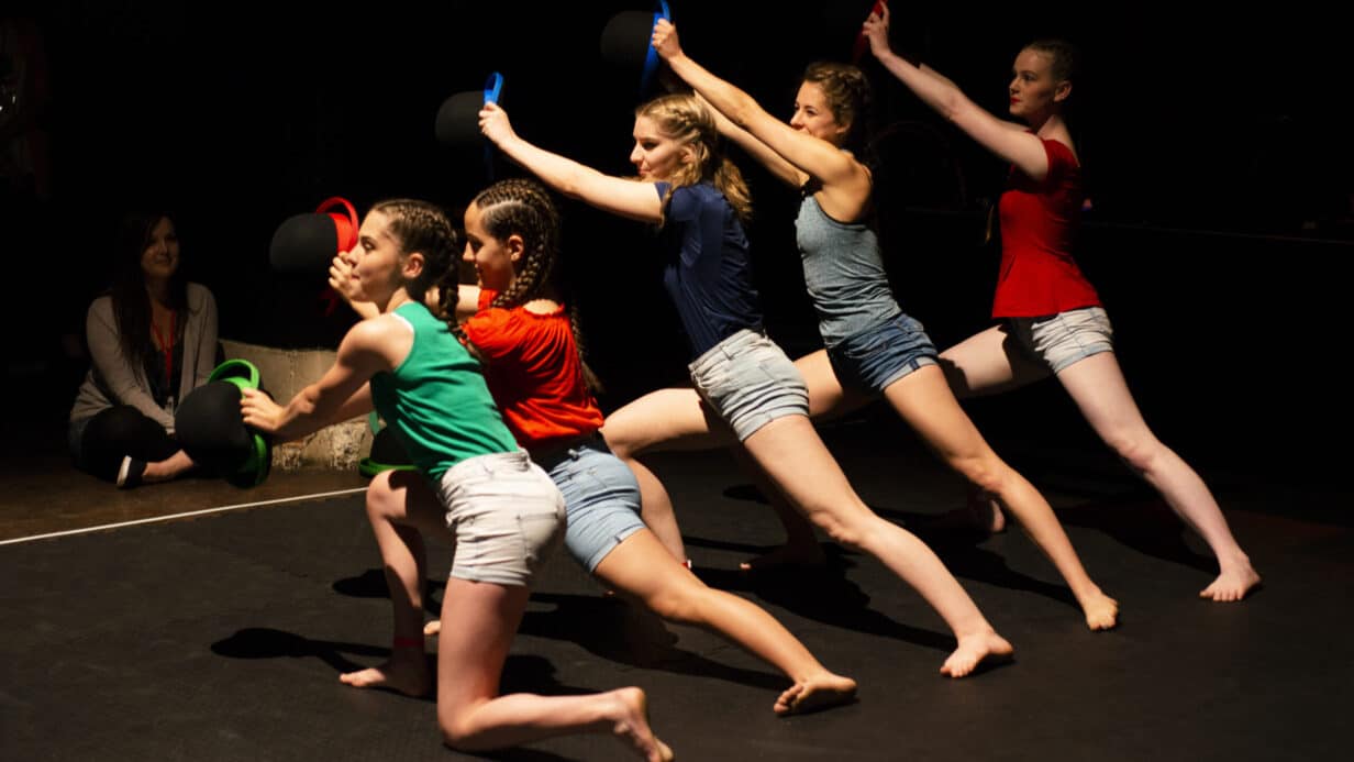 A group of girls performing a dance act at the Drill House