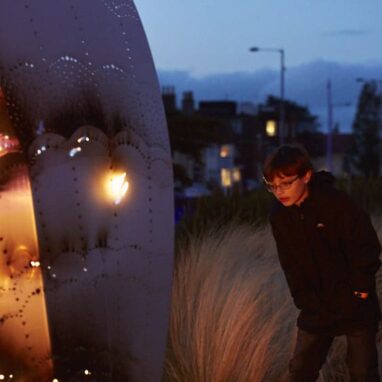 A child observing an exhibit at Fire on the Water