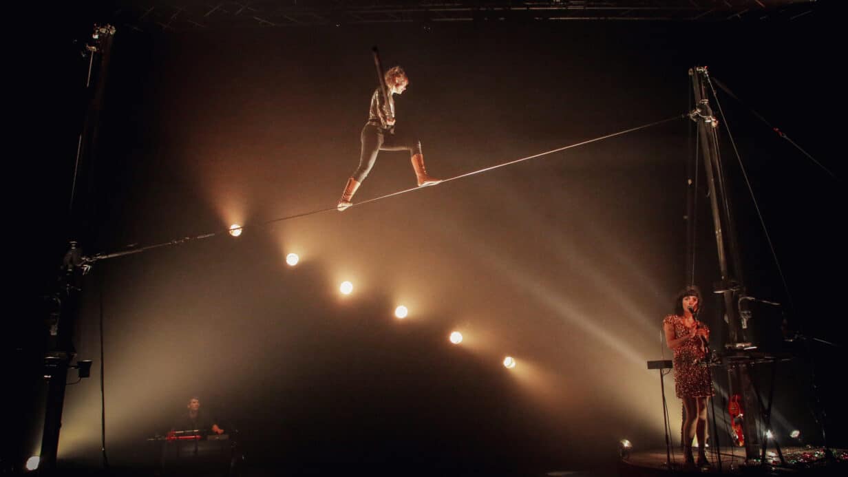 Person on a tightwire with atmospheric lights