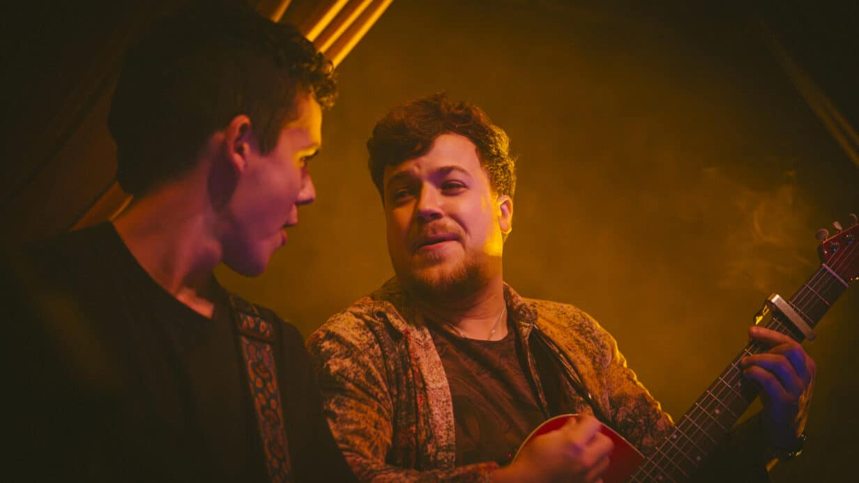 Musicians on stage in a warm amber light