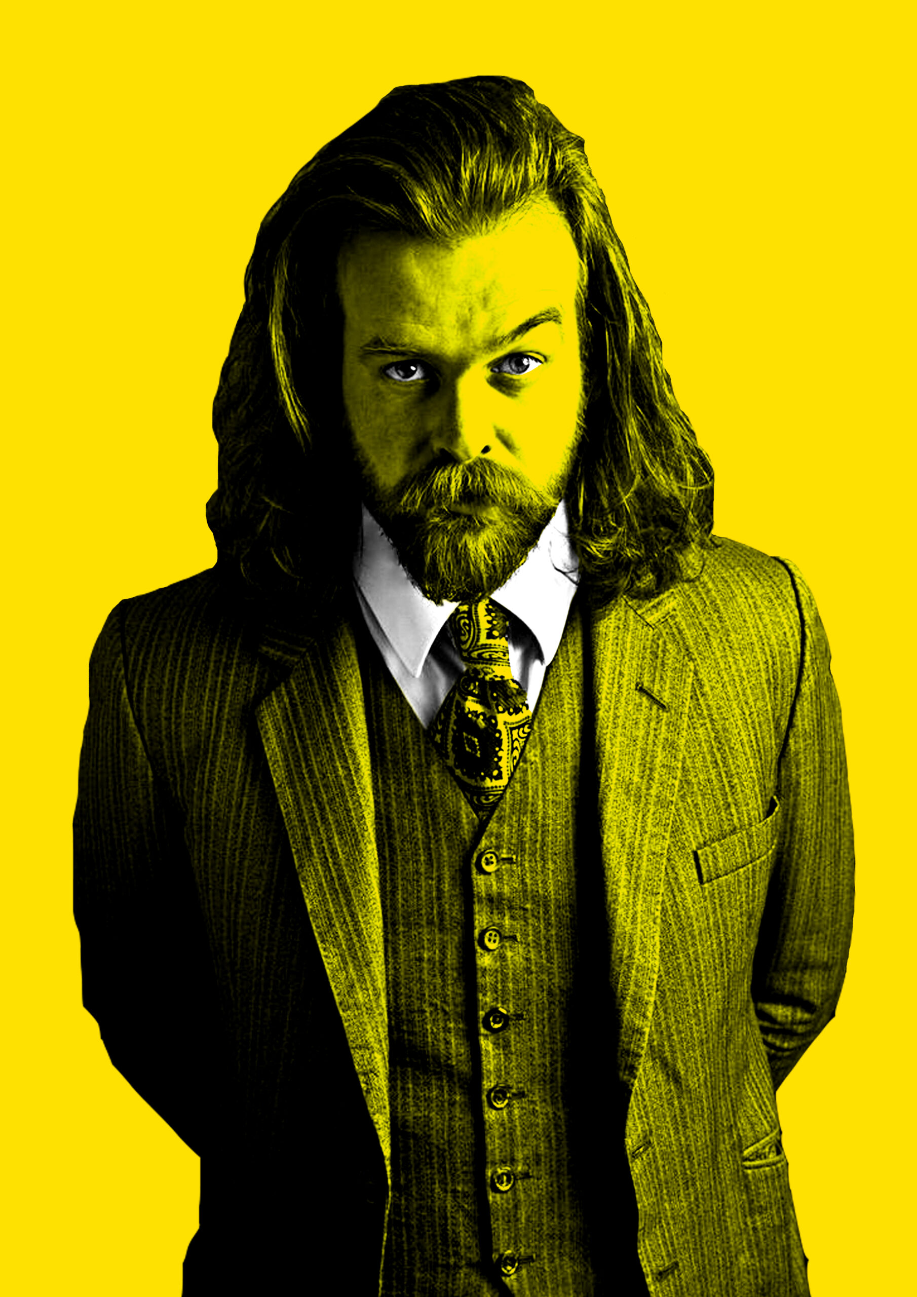 A person with long hair and a beard raising one eyebrow with a yellow background.
