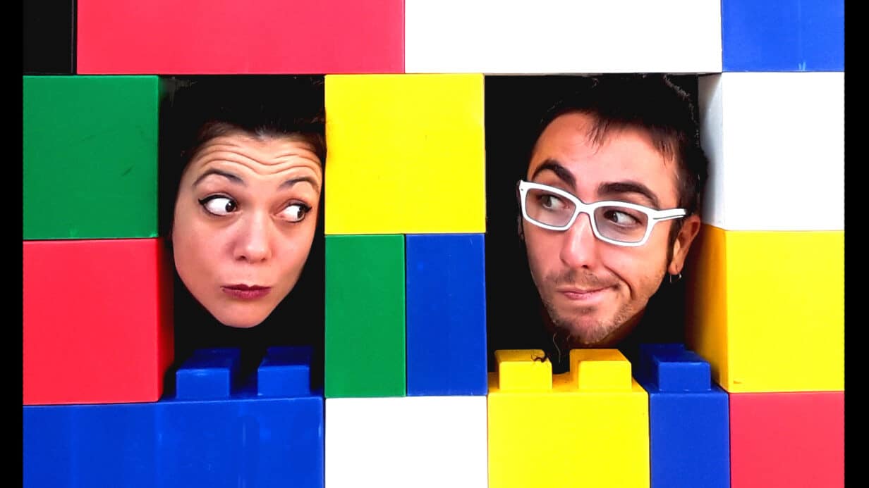 Two people with colourful bricks surrounding their heads