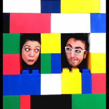 Two people with colourful bricks surrounding their heads