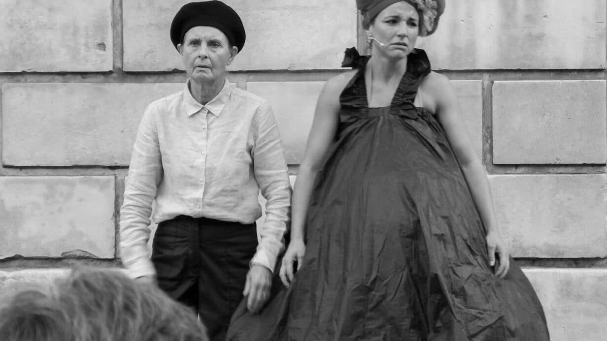 Black and white photo - two performers look sad