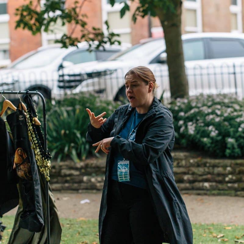 A sign language interpreter gestures.