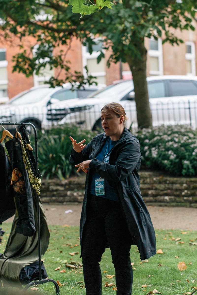 A sign language interpreter gestures.