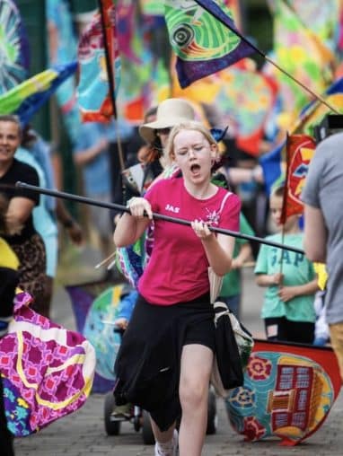 Child dancing with a flag