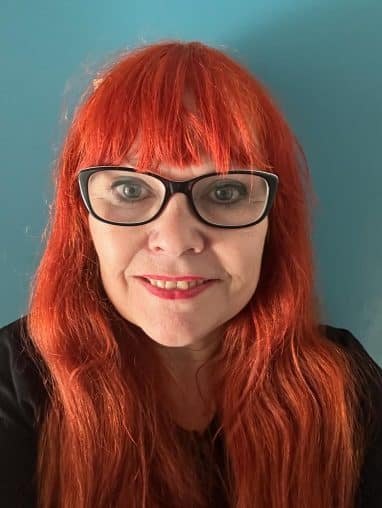 Lady with red hair and glasses