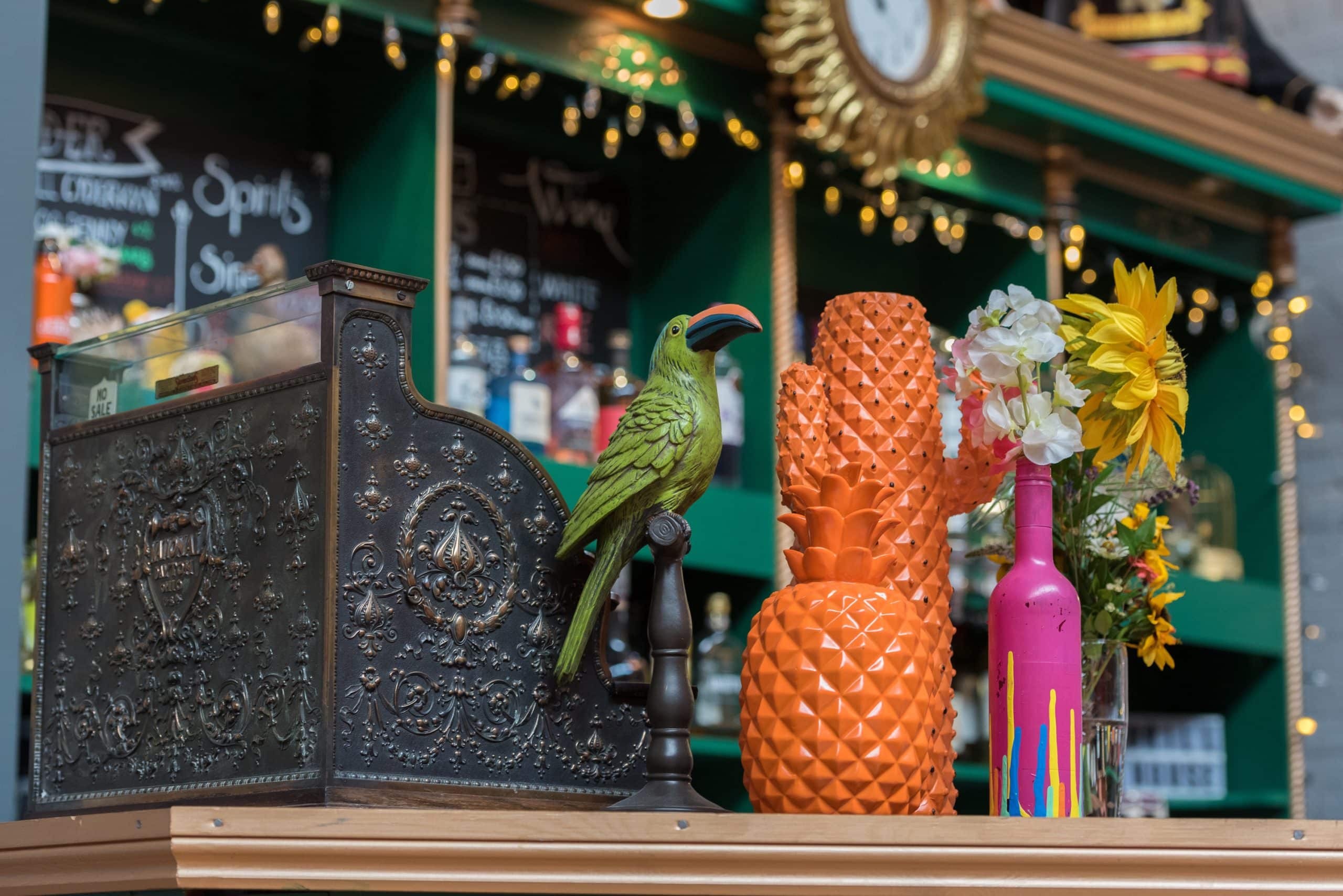 Drinks bar decorated with pineapples and parrots