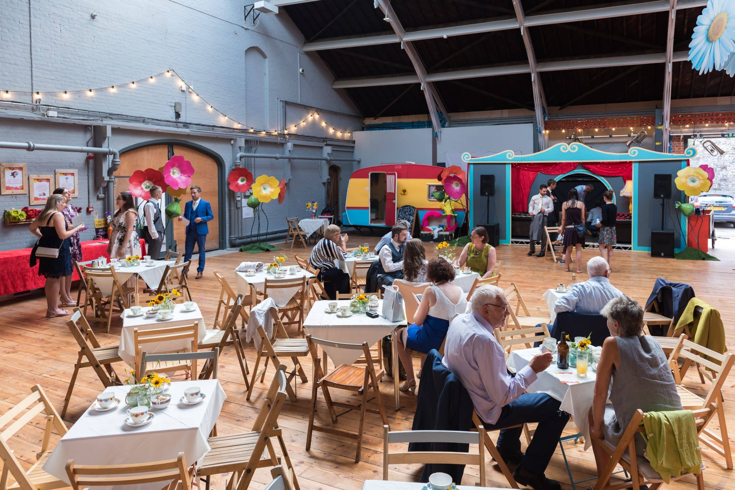 Wedding guests sat on tables and chairs