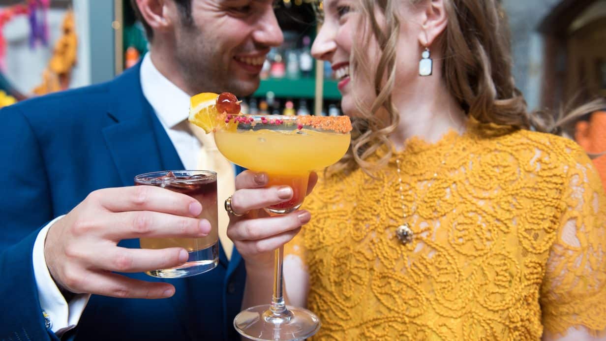 Couple cheersing cocktails