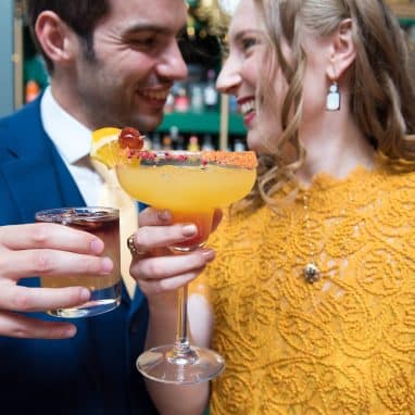 Couple cheersing cocktails