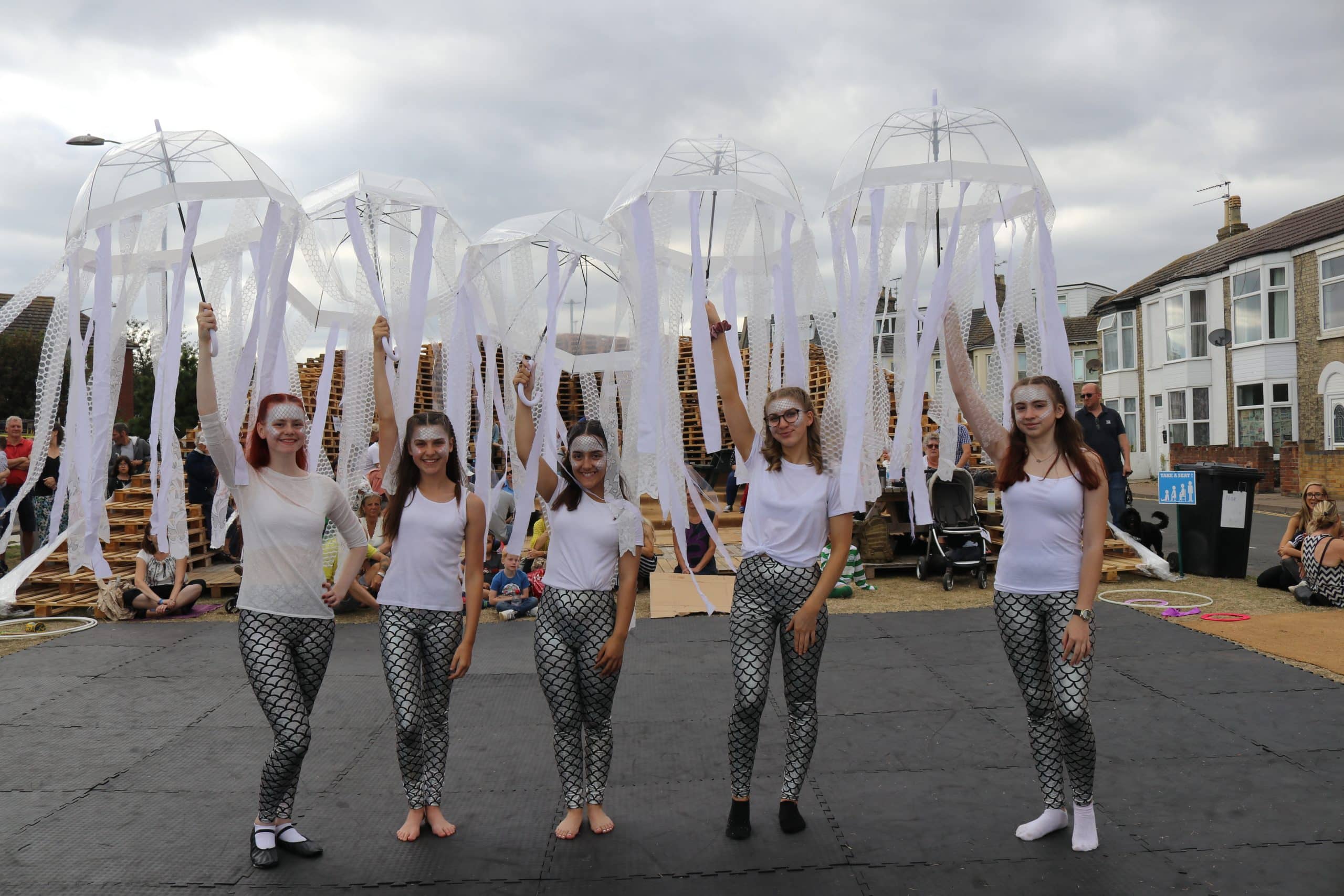 Circus performers dressed as jelly fish