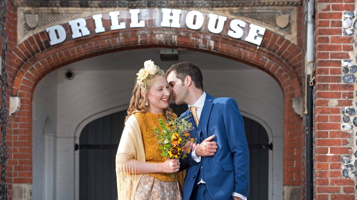 Couple pose outside the Drill House