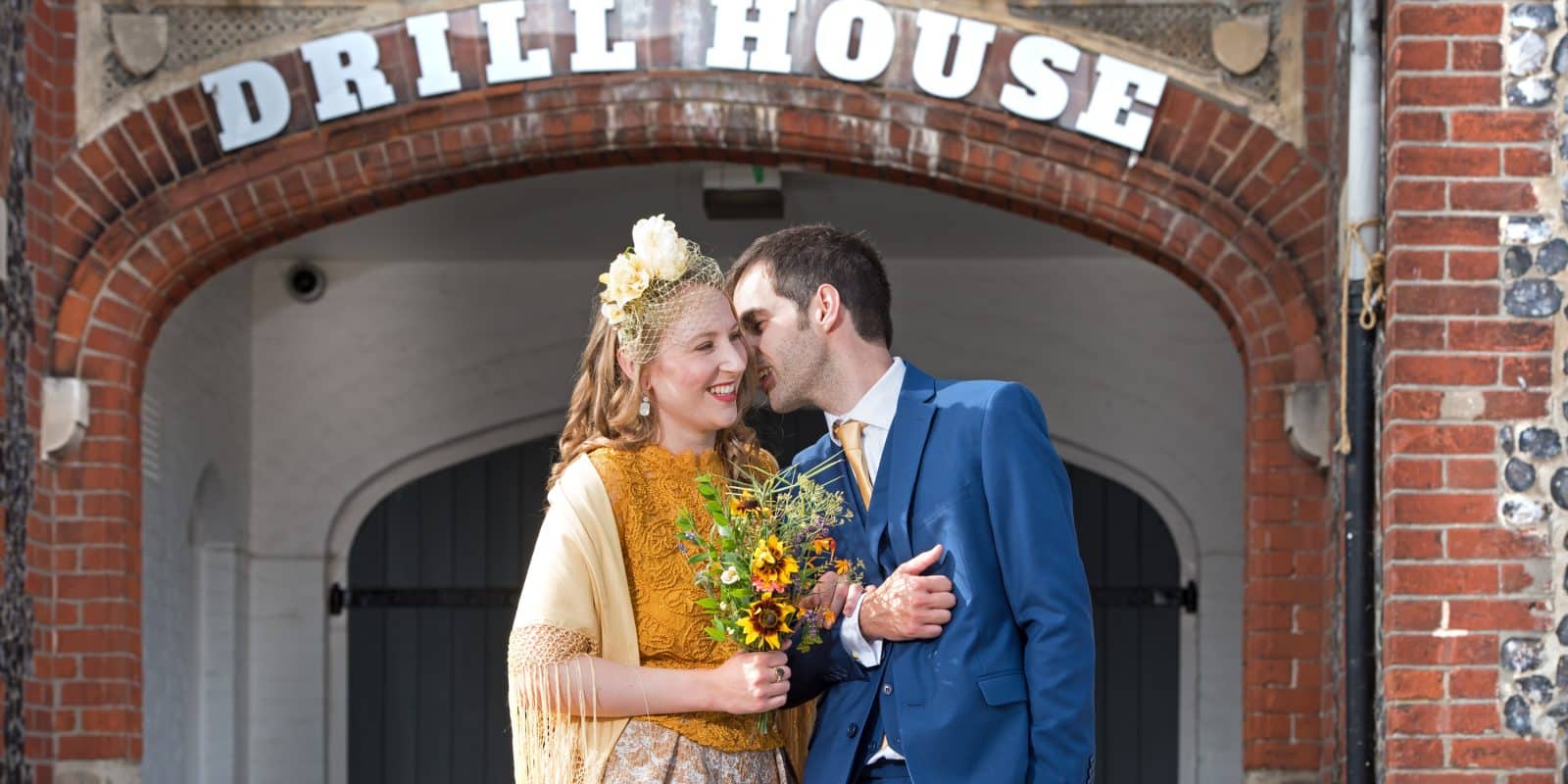 Couple pose outside the Drill House