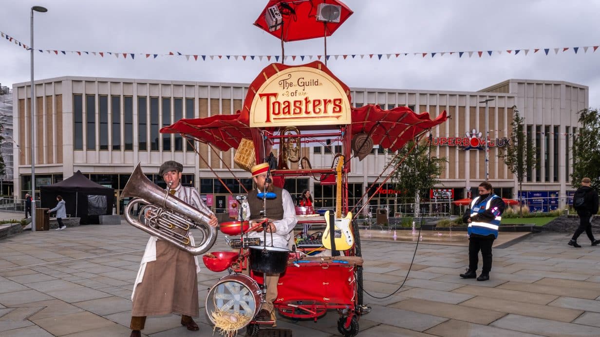 Band dressed as cooks with instruments and contraptions