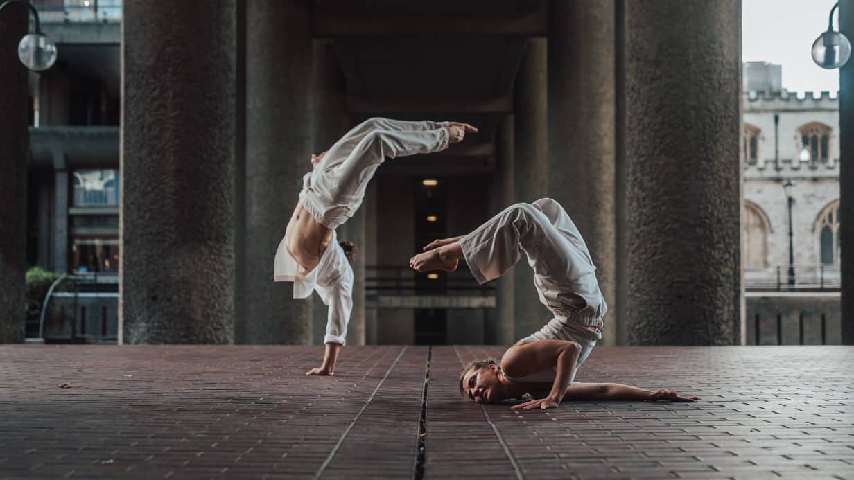 Dancers jump over each other