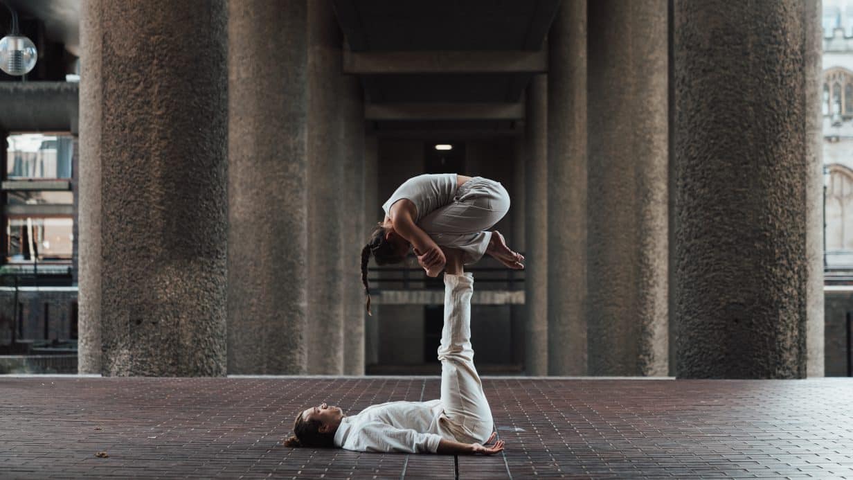 Man balances dancer on his legs