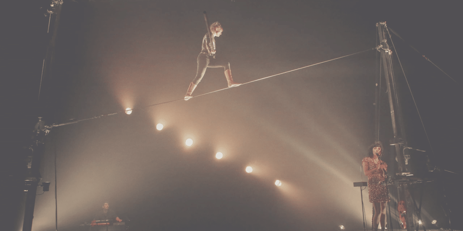 Person on a tightwire with atmospheric lights