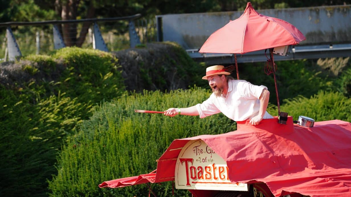 Man under an umbrella pointing