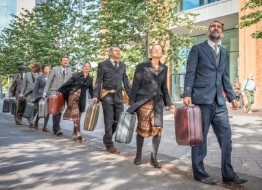 PRESSPHOTO – Kamchatka ©Aaron J. Law – HHProducties HHProducties People dressed in suits in a line carrying suitcases
