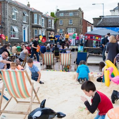 Deck chairs and sand on a street