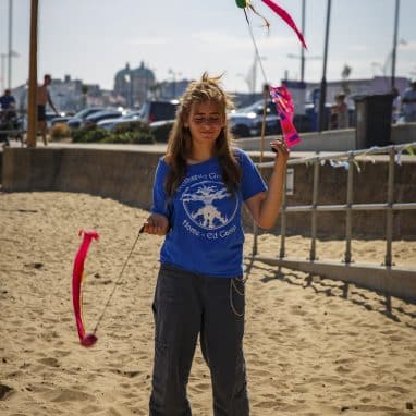 Girl doing poi on the beach