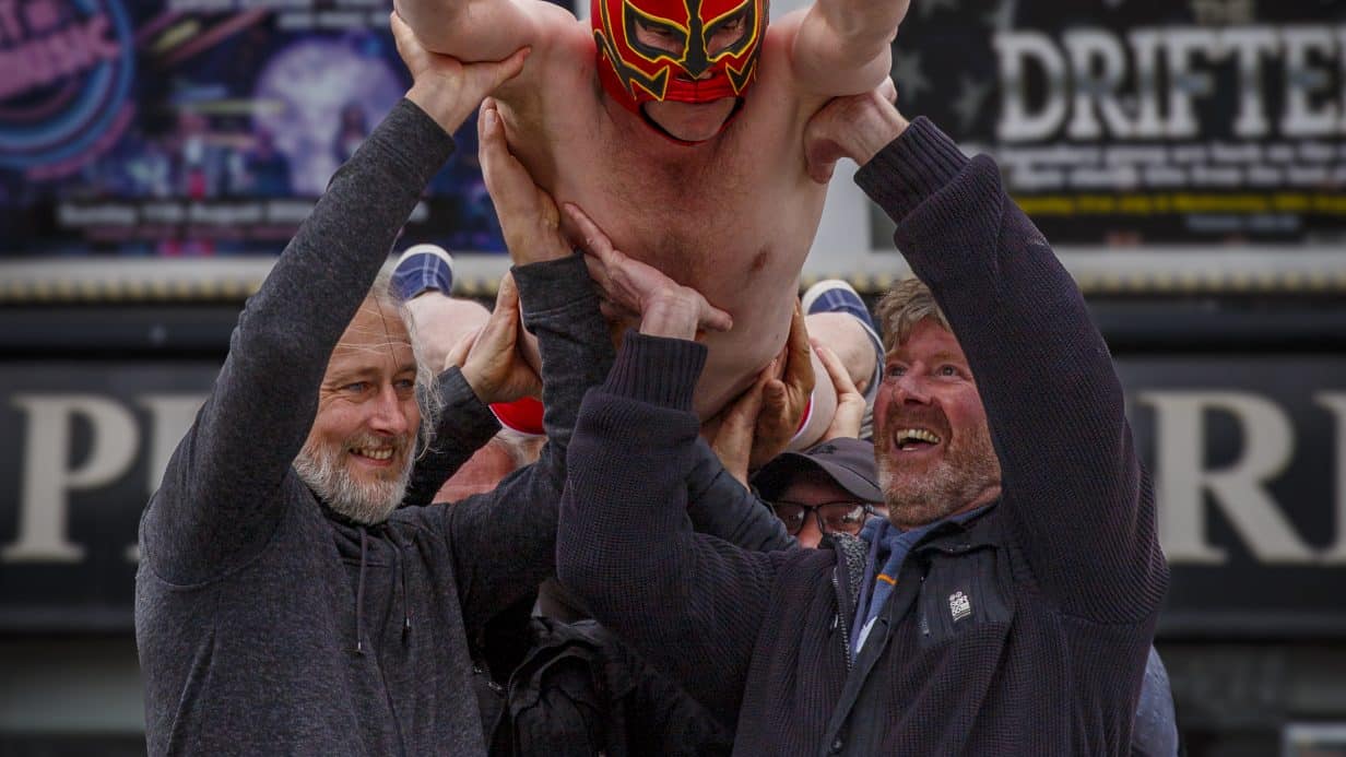 Man in wrestling mask diving