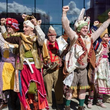 People cheering in cool outfits