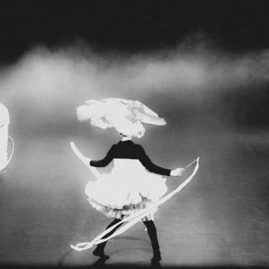 Black and white photo of circus performers and person dressed as polar bear