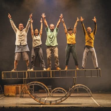 5 people balancing on a structure