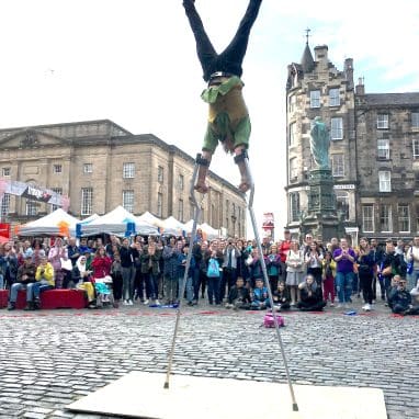 Man balancing upside down on two crutches