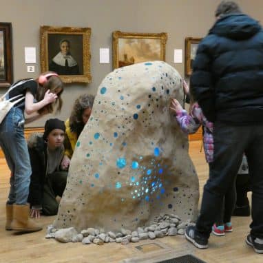 P1000085 People in a musuem touching a sculpture