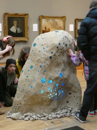 P1000085 People in a musuem touching a sculpture