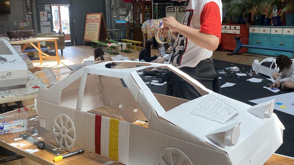Boy making a car out of cardboard