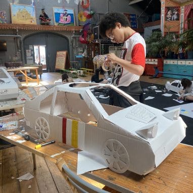 Boy making a car out of cardboard