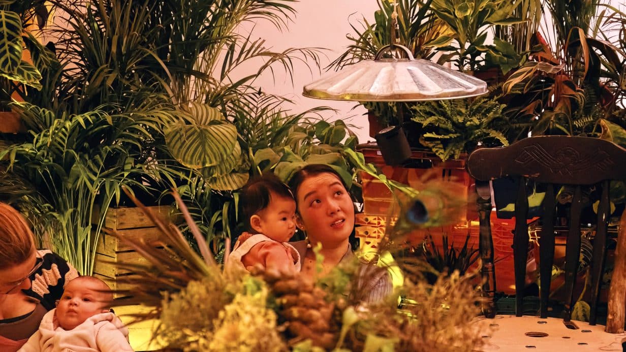 Mother and baby in world with plants