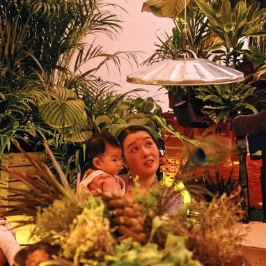 Mother and baby in world with plants