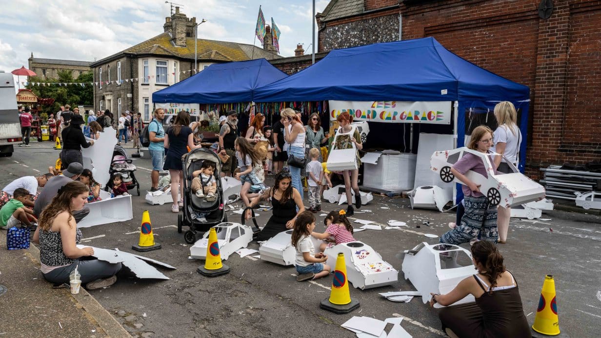 People making cardboard cars