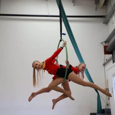 Two aerial artists on an aerial hoop