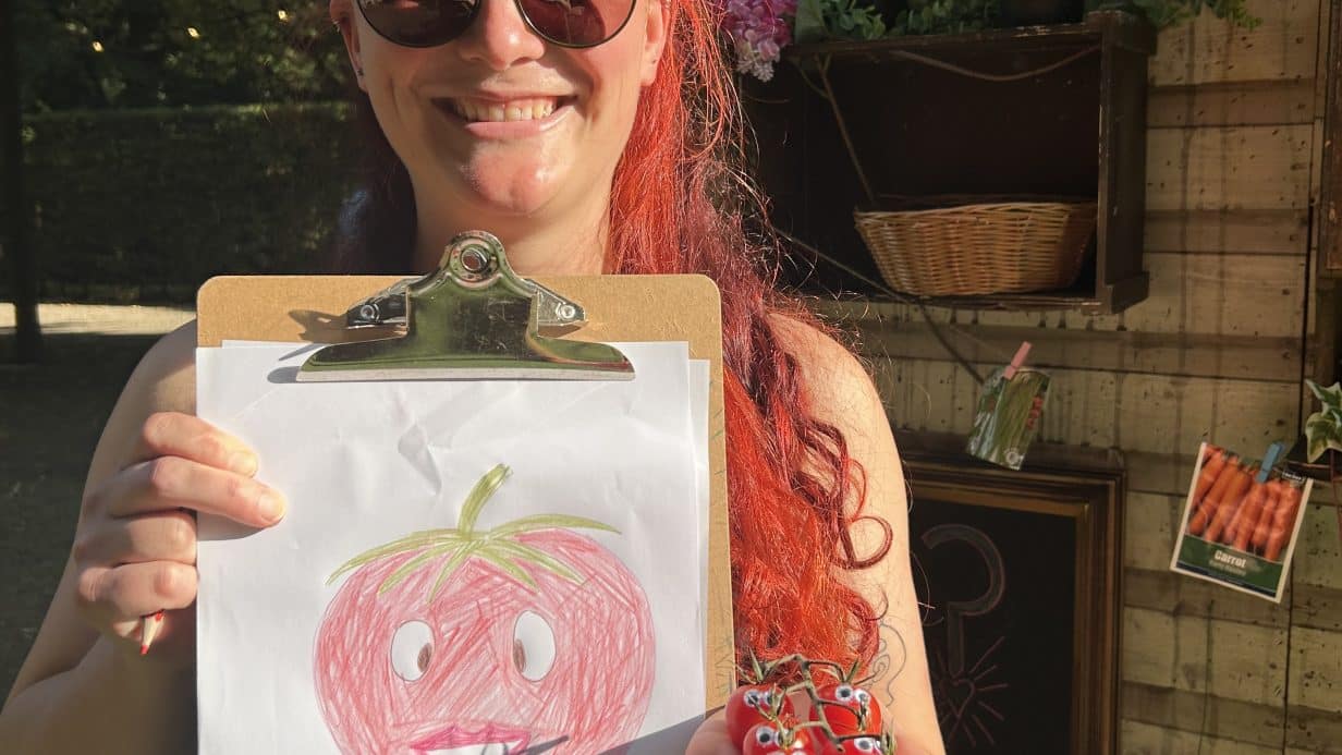 Person showing their artwork at The Magic Shed