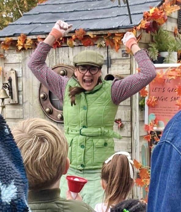 Woman cheering outside The Magic Shed